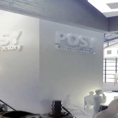 Innenansicht eines modernen Raumes mit dem Schriftzug 'POS OutputFactory' an der Wand.